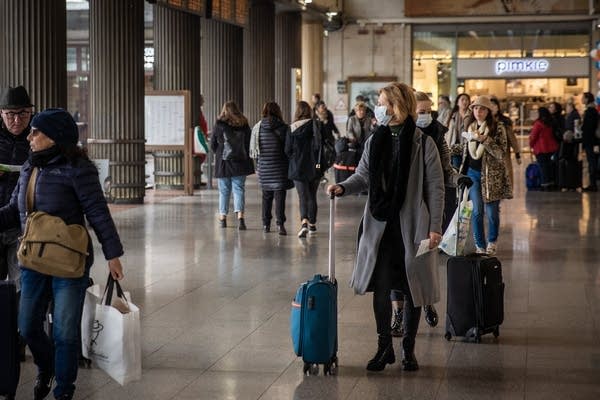 People wearing protective masks at Santa Lucia Train Station in Venice, Italy, on February 24, 2020. More than 210 people were infected by Covid-19 in Italy, with 5 people deaths. Italy is at the third place in the world ranking as infected countries, after China e South Korea. Italy has disposed the closure of schools, university, pubs and imposed a stop to religious functions in Lombardia and Veneto regions.