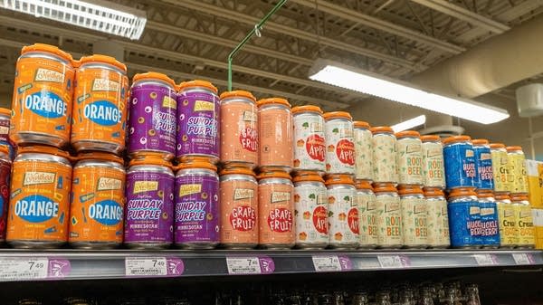 Cans of Northern Soda sit on a grocery store shelf.