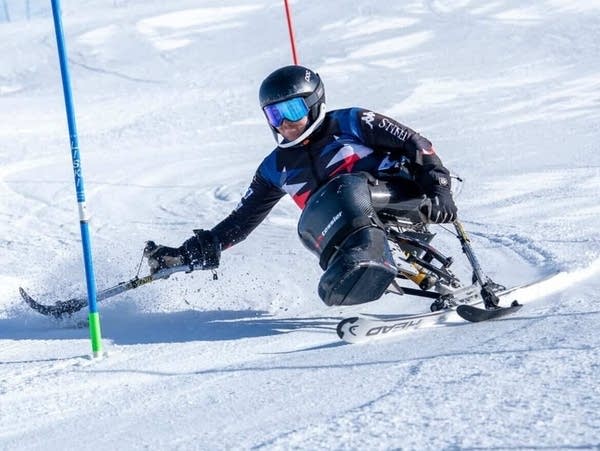 An athlete skis down a course.