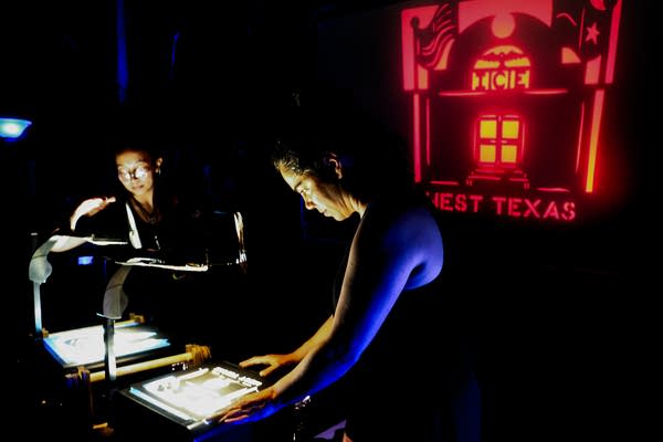 Two people work with lights and shadows.