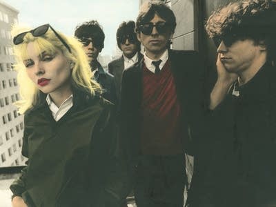 Five people standing on a rooftop in New York 