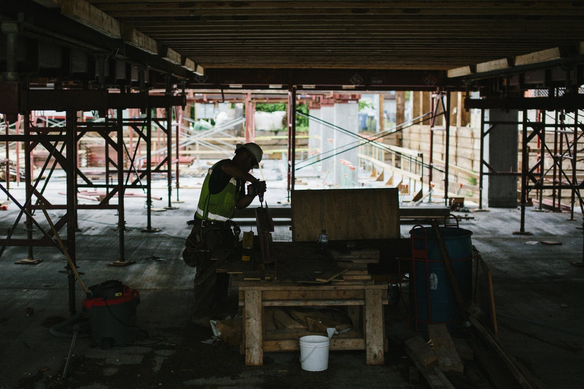 A Thor employee uses a drill.