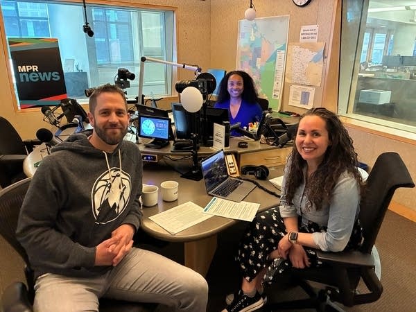 three people pose for a photo in an mpr news studio
