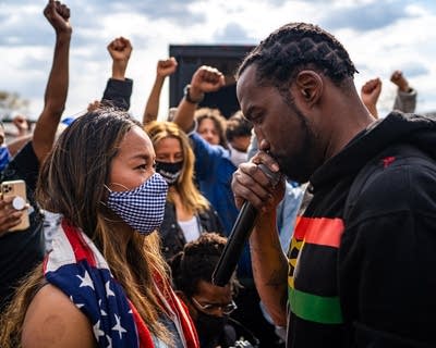 A man and a woman look at each other.