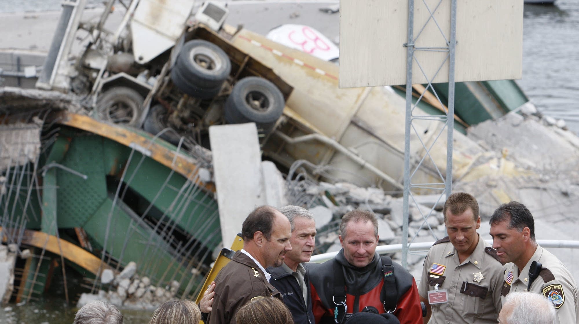 George W. Bush meets rescue workers at the bridge site.