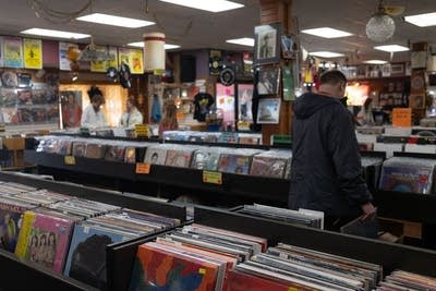 People browse records in a record store