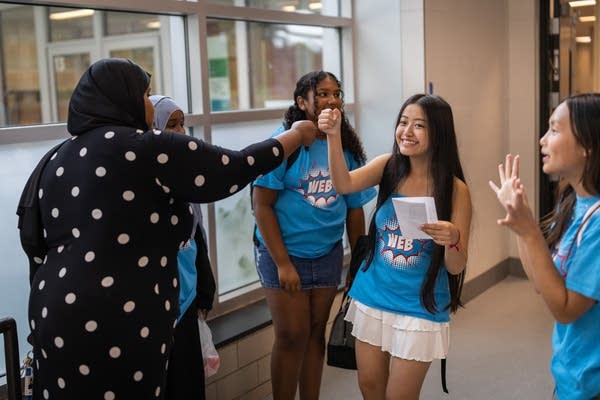A student fist bumps