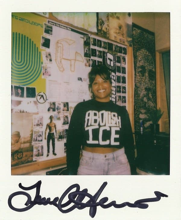 a signed polaroid with a woman in it