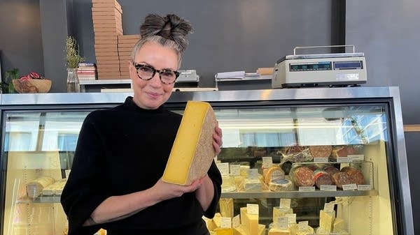 Lydia Clarke in front of her "happy place," the cheese case.