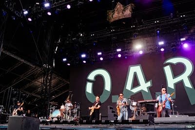 A band performing on a large outdoor stage
