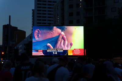 A tv shows a soccer game in a park