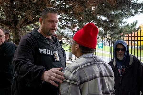 St. Paul Police officer Dean Koehnen talks to Jesse Fenny.