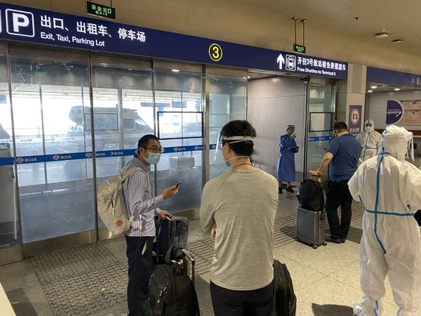 This photo taken on June 18, 2022 shows inbound passengers waiting to be taken to quarantine-designated destinations from the Beijing International Airport in Beijing. (Photo by Leo RAMIREZ / AFP) (Photo by LEO RAMIREZ/AFP via Getty Images)