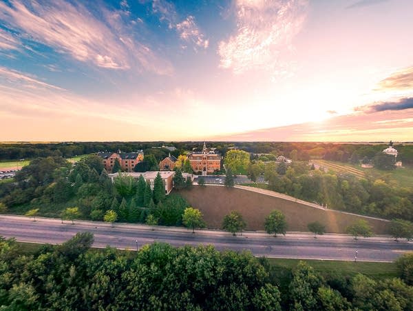 The sun rises over a college campus.