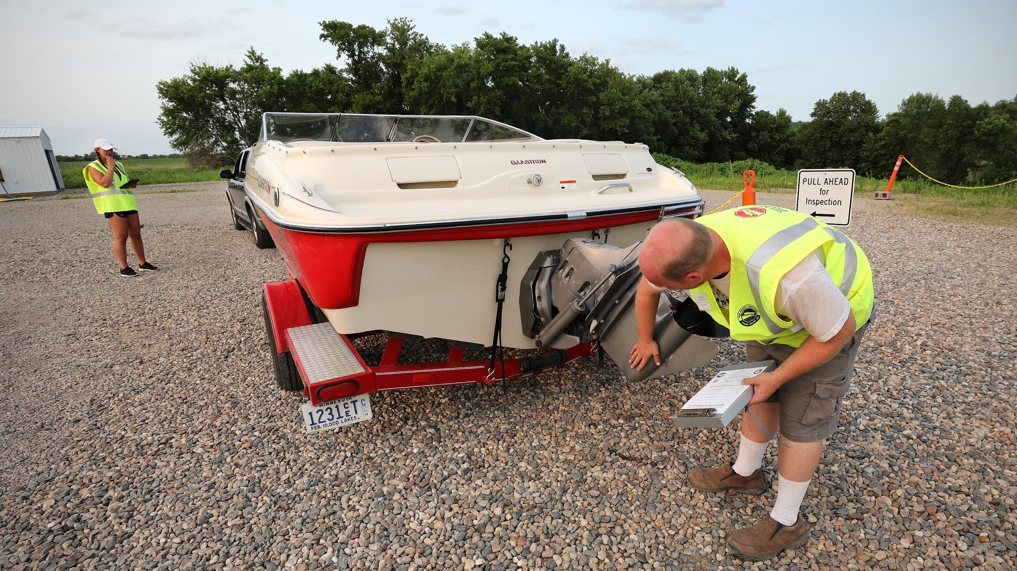 Bradley Hansen and Hannah Purcell inspect a boat.