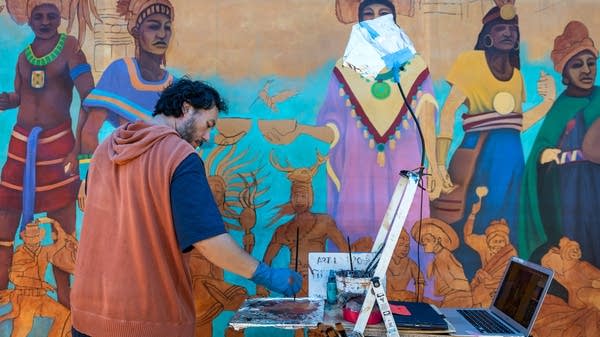 A person painting a mural