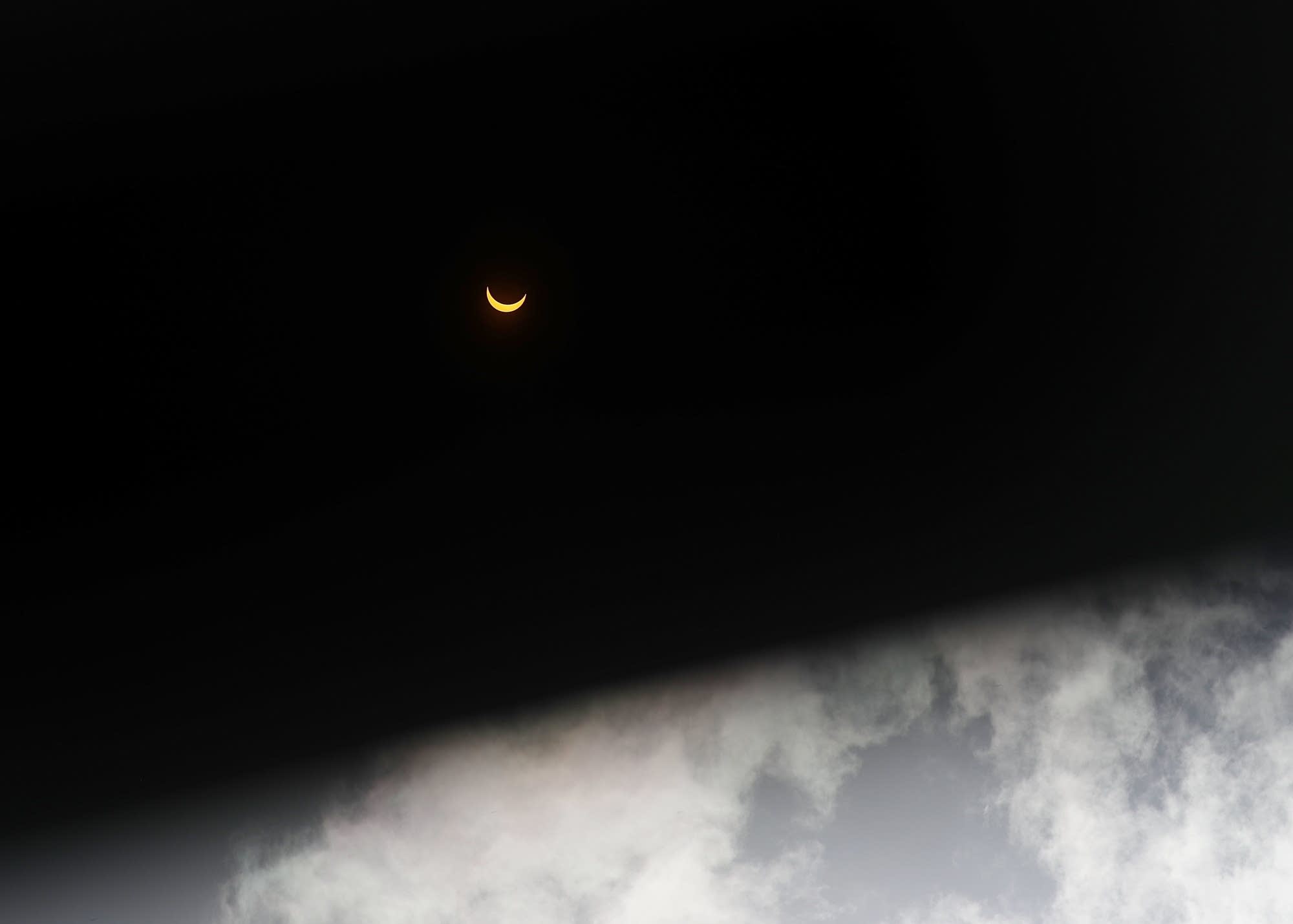 The solar eclipse viewed through dark eclipse glasses in Miami.