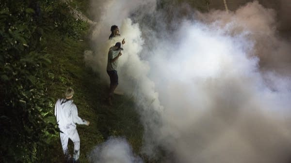 Protesters are hit with smoke bombs