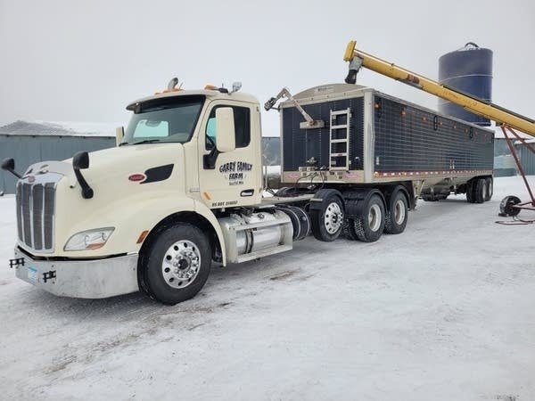 A semi-truck with the Garry Family Farm logo