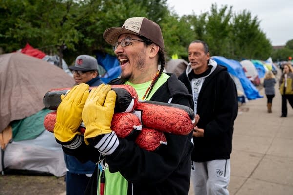 Volunteers help make sure those living at Franklin-Hiawatha encampment have food