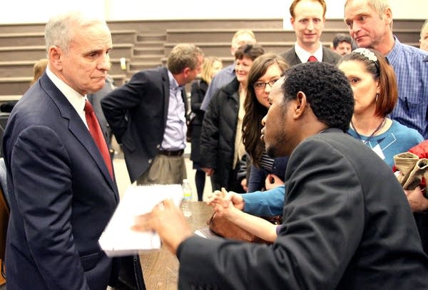 Dayton questioned on gun law proposals, education in St. Cloud town hall