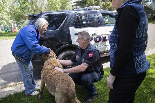 Kenyon police Chief Lee Sjolander greets Dianne Vagness and her dog, Max.