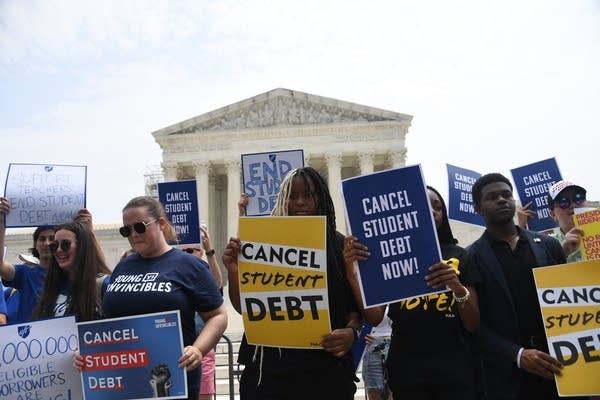 Supporters of student debt forgiveness demonstrate outside the US Supreme Court on June 30, 2023, in Washington, DC. The US Supreme Court dealt President Joe Biden a significant political setback Tuesday when it overruled his key program to cancel the student debt of millions of Americans. The court said Biden had overstepped his powers in cancelling more than $400 billion in debt, in an effort to alleviate the financial burden of education that hangs over many Americans decades after they finished their studies. (Photo by OLIVIER DOULIERY / AFP) (Photo by OLIVIER DOULIERY/AFP via Getty Images)