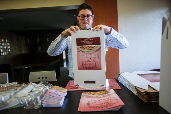 Rabbi Shloime Greene works on putting together "Seder to go" boxes.