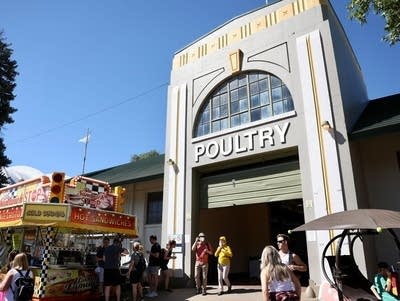 Fairgoers enter the front of the Poultry building