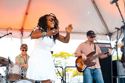 A band performing on an outdoor stage