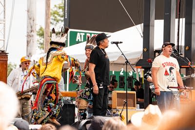 Dylan Jennings Blessing and Bizhiki performing on an outdoor stage