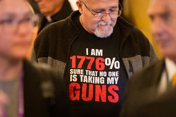 A man wears a pro-gun shirt
