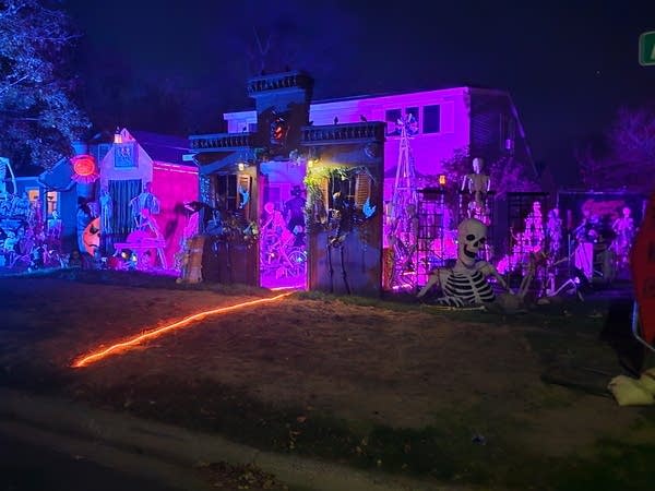 A house decorated for Halloween with a purple light
