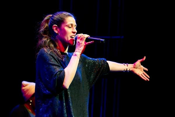 a woman singing on stage