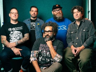Five members of Motion City Soundtrack pose for a photo.