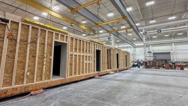 Workers on the RISE factory floor build apartment units with everything from appliances to trim installed and finished.