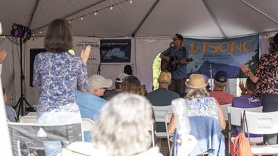 jeremy messersmith on stage and crowd clapping