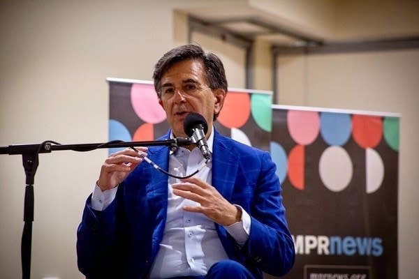 A man speaks into a microphone.
