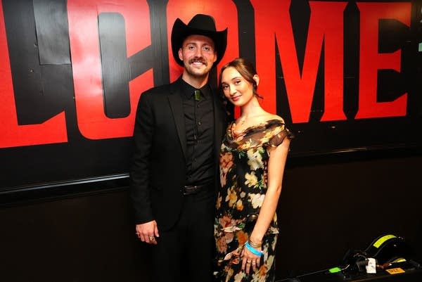 Two people pose for a photo together when attending an awards event