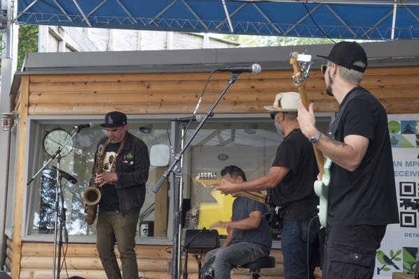 A band performing on an outdoor stage at a fair