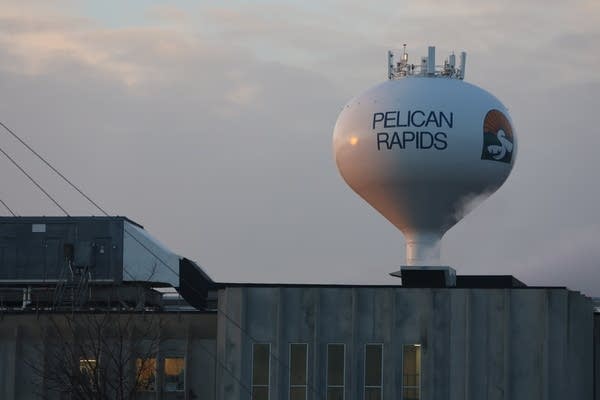 A water tower is seen in the distance reading "Pelican Rapids."