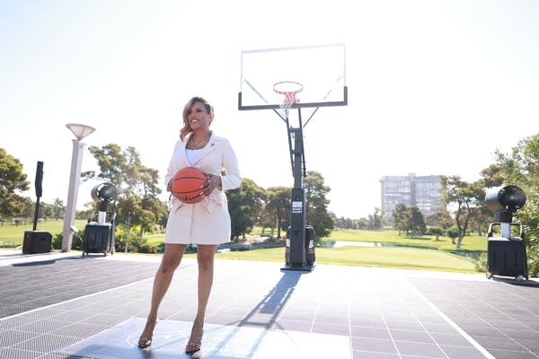 woman stands in a basketball court