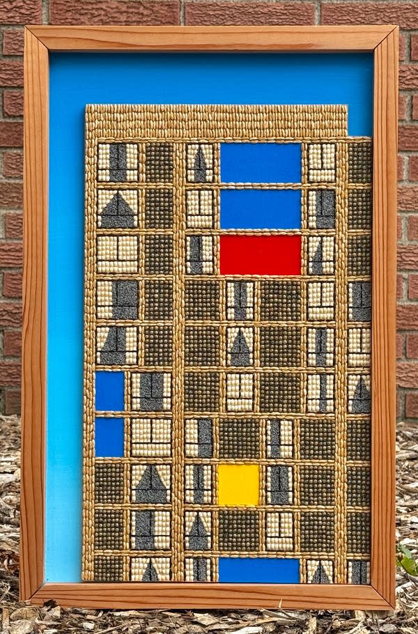 A seed art illustration of the Cedar-Riverside Plaza apartments on a blue background.