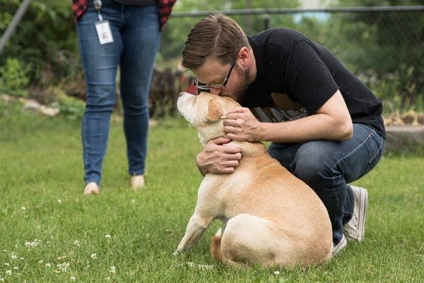 Mike Liay kisses his dog Archie's head in his backyard in Northeast Minneapolis.