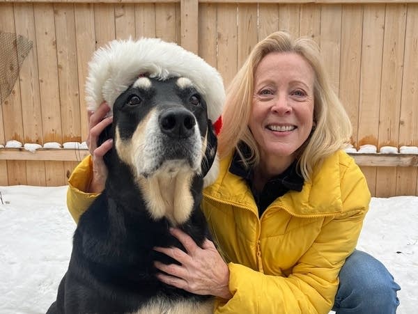 A woman poses with her dog.