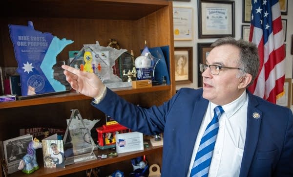 A man points to a sign