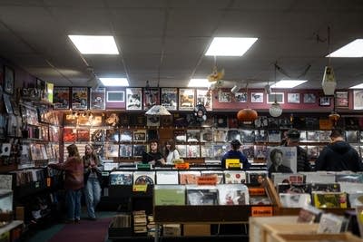 People browse records in a record store