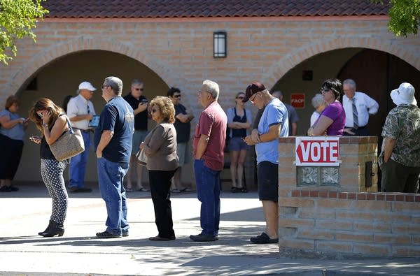 Voters wait in line in the Arizona primaries