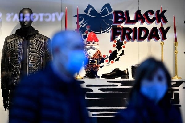 A sign announces a price markdown for Black Friday on the display window of a shop in Madrid on November 23, 2020.