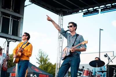 A band performing on an outdoor stage